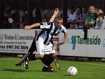 Callum Warburton shrugs off a challenge and comes away with the ball