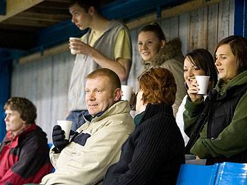 Supporters watch the game