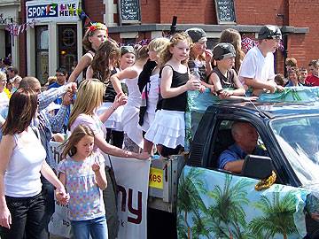 Young dancers from The Academy wind their way along the parade route