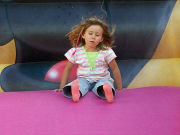 Slide Away! A toddler takes a slide at the funfair at Springfield Park 