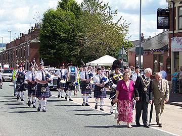 The Oldham Pipe Band follow the Mayor, Mayoress and MP Jim Dobbin at the head of the parade