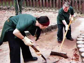 Day service assistant Ruth Babbington working in Queens Park Children's Play Area with David Casey