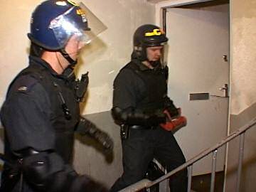 Police break down door in drugs raid