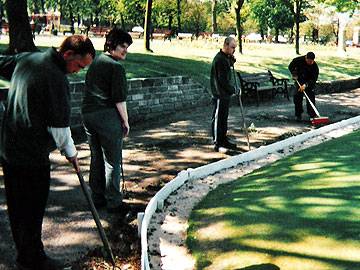 Hoeing round the bowling green at Queens Park; service users Stephen Conway, Dawn Barlow, Colin Moorhouse & Lee Radcliffe