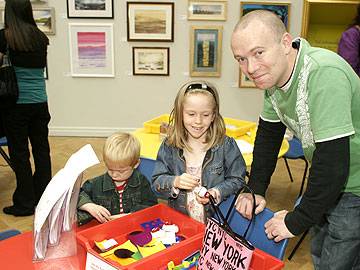 Charlie, 2 and Emily 6, with dad Ken at the art adventure table