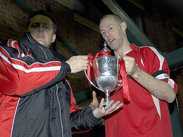 Captain Michael Barker Lifts The Trophy