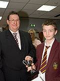 Jack Ryder, Prosecution Lawyer receives the winners’ cup from Martin Hill of Rochdale’s Crown Prosecution Service