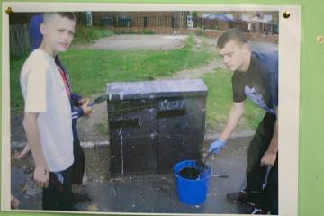 Clean-up operation: Youngsters clean graffiti at one of the group's community projects