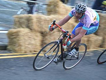 One of the cyclists races onto Newgate, where hay bales were placed in case riders fell