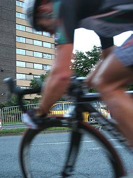 A close-up of a cyclist on St Mary's Gate with one of the seven sisters flats in the background