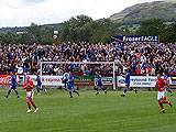 The teams run out before in the game in front of the Rochdale fans