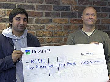 Dog & Partridge owner Amir Nazir hands a cheque to RDSFL Chairman Jim Matthews