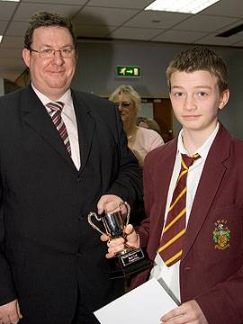 Jack Ryder, Prosecution Lawyer receives the winners’ cup from Martin Hill of Rochdale’s Crown Prosecution Service.