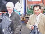 Council Leader Paul Rowen helps to load up the container