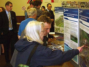 Members of the community look at the development proposals