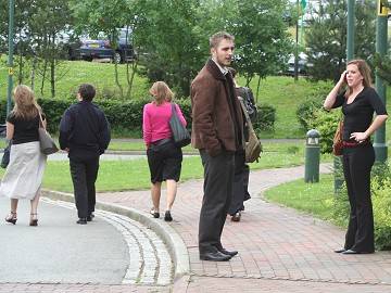 Bemused staff stand around in the car park