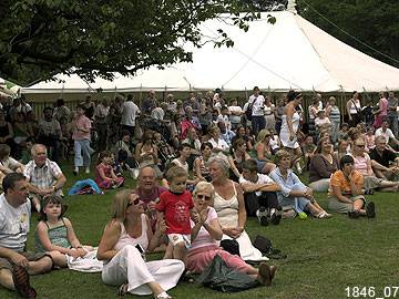 People gather on the lawn in front of the theatre