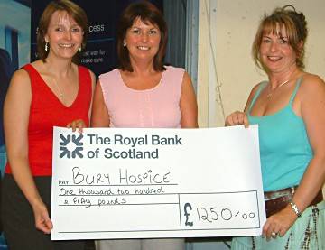 Bury hospice staff receiving a cheque for £1,250