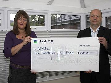 Judith Pratt of Lambourne Images hands a cheque to RDSFL Chairman Jim Matthews