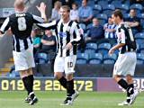 Adam Le Fondre celebrates with Gary Jones and Adam Rundle after scoring Dale's third goal