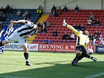 A Chris Dagnall header goes narrowly wide of the Huddersfield goal