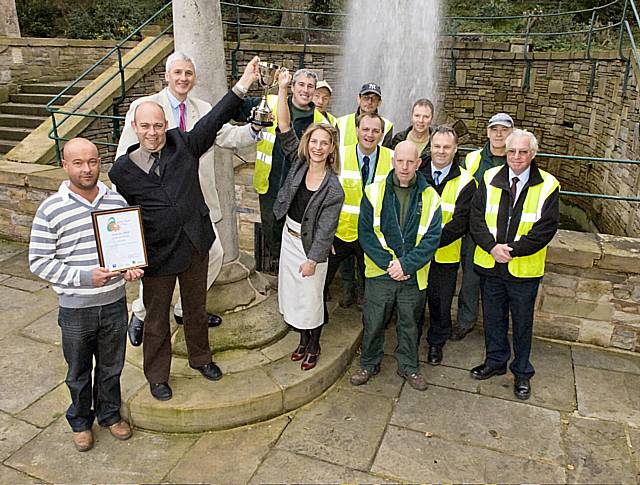 Rochdale Council’s Dave Woolrich, Andrew Whitehead, and Councillors William and Wera Hobhouse hold the North West In Bloom Heritage Award trophy aloft at Packer Spout.