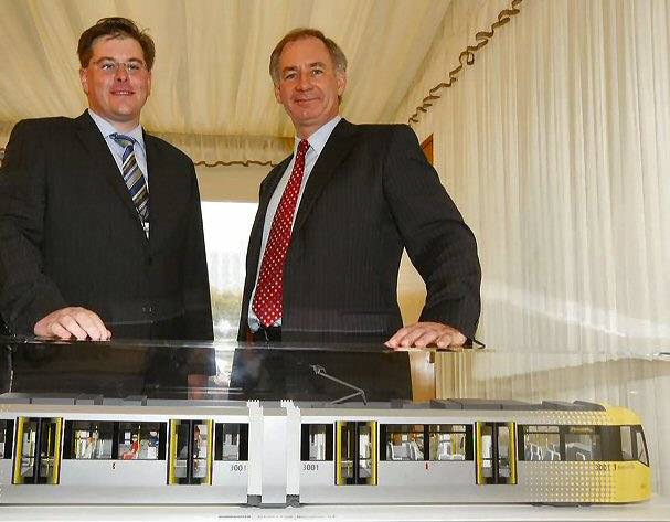 Councillor Matt Colledge, Chairman of Greater Manchester Passenger Transport Authority, showing the new Transport Secretary Geoff Hoon a model of Greater Manchester's new look trams.