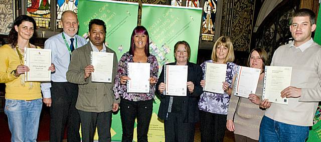 Qualified to care? Staff receive their certificates at Rochdale Town Hall after successfully completing their course.