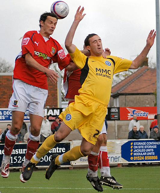 Rory McArdle goes up for a header.