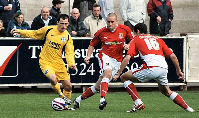 Chris Dagnall looks to get past Scott Drummond.