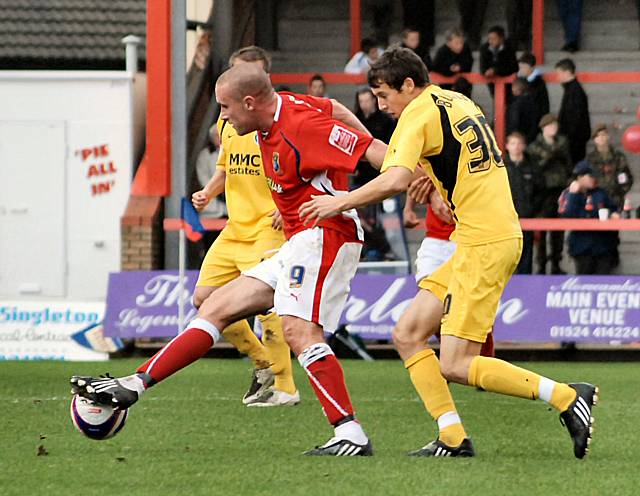 Wayne Curtis holds off Will Buckley.