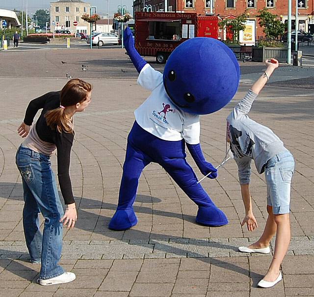 The PCT mascot exercises with visitors to the event