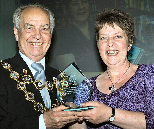 Lynn Byrne, a library assistant is presented with her trophy by the Mayor, Councillor Robin Parker.