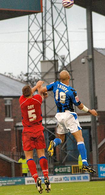 Rhys Day and Lee Thorpe go up for a header.