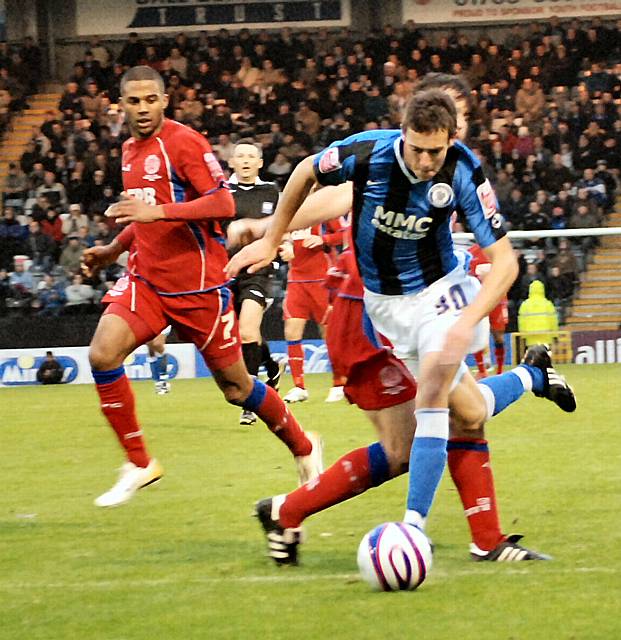 Will Buckley stumbles under Blackburn's challenge but Dale are denied a penalty.