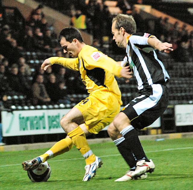 Chris Dagnall holds off Jamie Clapham.