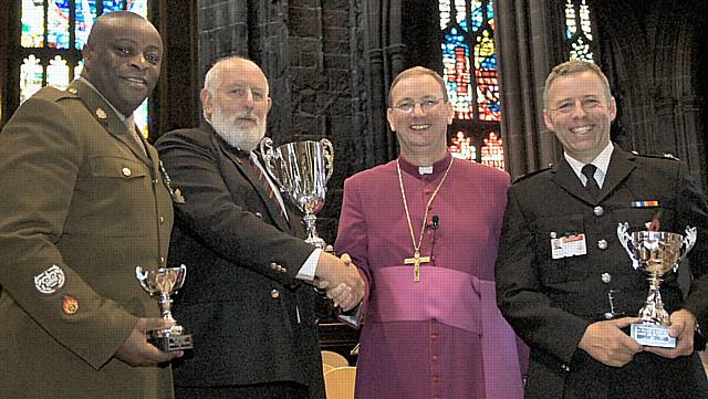 Winners of the poll alongside the Bishop of Middleton. From left to right: (3rd Place) Soldiers, represented by Warrant Officer Lutha Magloire, (1st Place) Parents, represented by  Graham Higson, Bishop of Middleton, Rt Revd Mark Davies, (2nd Place) Firefighters, represented by Officer Steve Sherridan.