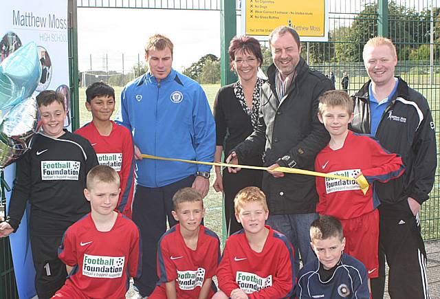 The Dale boss cuts the ribbon alongside the school's business and sports managers.