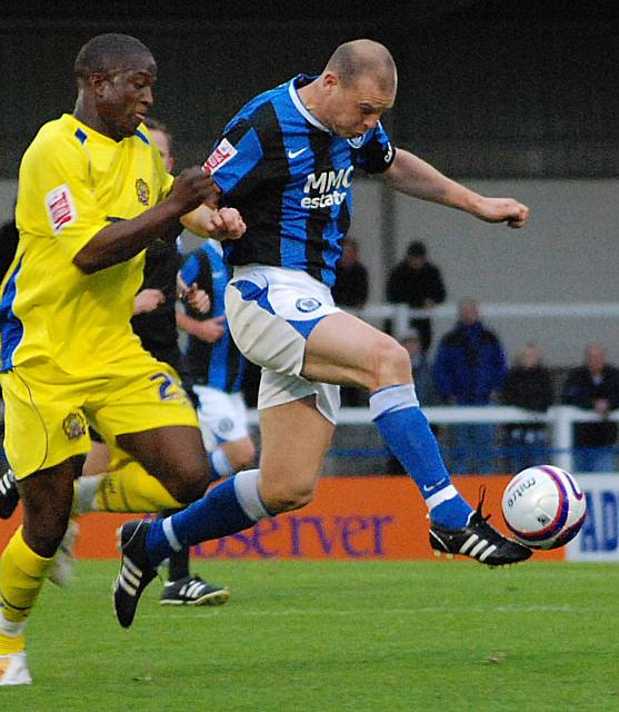 Gary Jones control the ball in front of Soloman Taiwo.