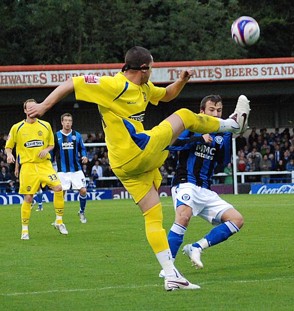 Mark Arber clears the ball from Adam Le Fondre.