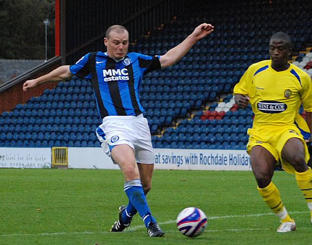 Jones stretches for the ball inside the Dagenham penalty area.