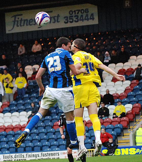 Arber and Rory McArdle rise for a header.