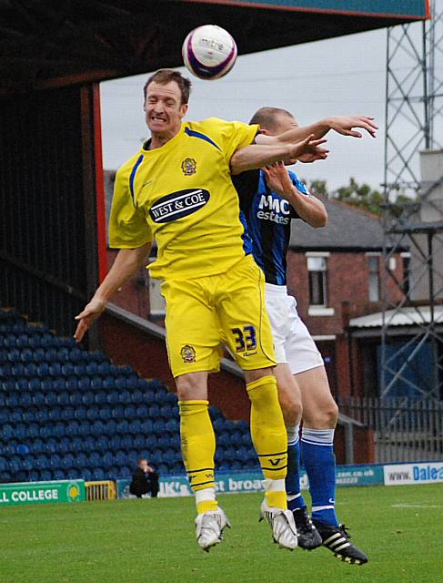 Peter Gain wins a header from Jones.