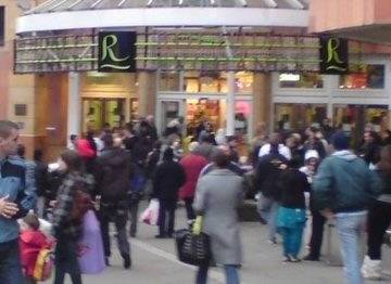 Store staff and customers stand outside the Rochdale Exchange Shopping Centre after it was evacuated this afternoon.