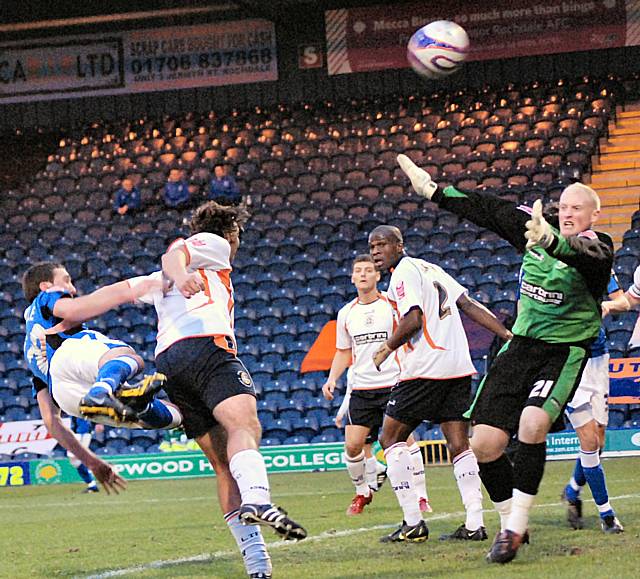 Rory McArdle flings himself at a header.