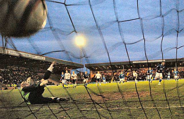 Adam Le Fondre's penalty hits the back of the net.