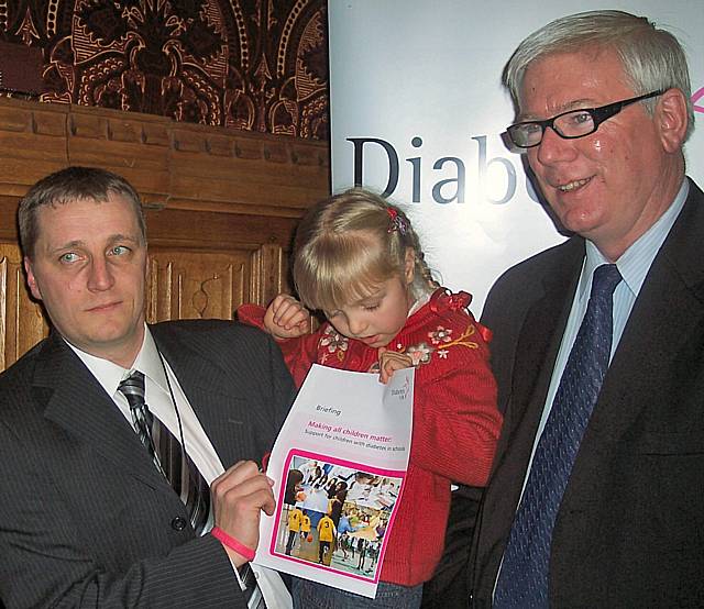 Olivia’s father Darren Fisher with Olivia and Paul Rowen MP promoting their cause in Parliament.