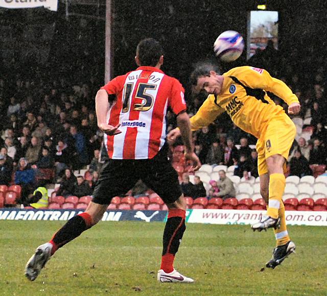 Dagnall tries to direct a header on goal.