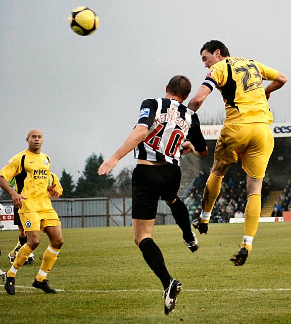 Rory McArdle wins an attacking header.