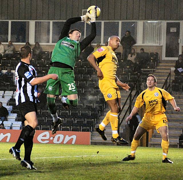 Forest Green's keeper lets a cross slip.